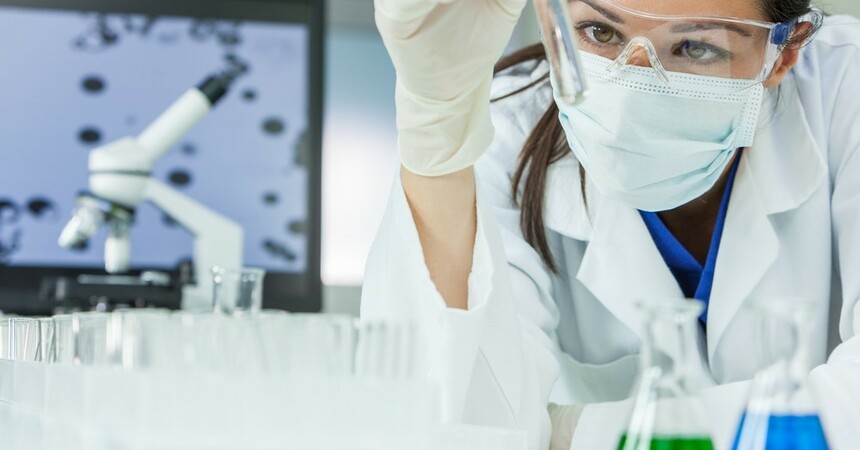 1920 1920 stock photo female medical or research scientist or doctor using looking at a test tube of clear solution in a 595303463