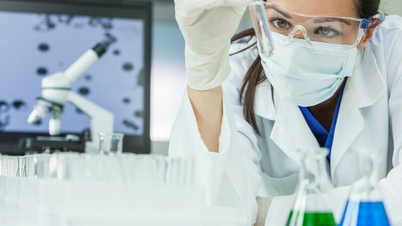 1920 1920 stock photo female medical or research scientist or doctor using looking at a test tube of clear solution in a 595303463
